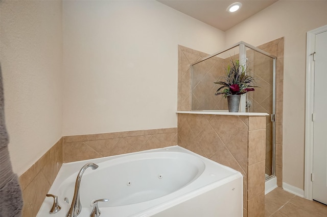 bathroom with independent shower and bath and tile patterned flooring