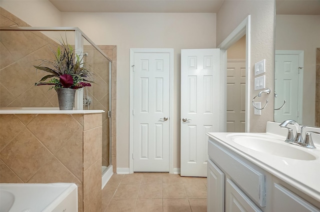 bathroom with tile patterned floors, vanity, and a shower with shower door