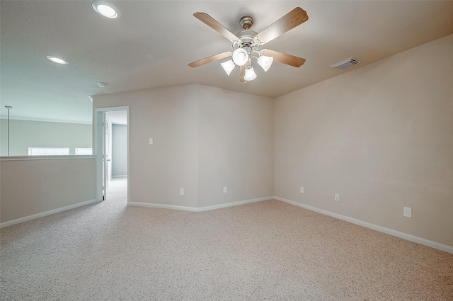 spare room featuring ceiling fan and light carpet