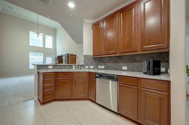 kitchen with backsplash, stainless steel dishwasher, sink, hanging light fixtures, and light carpet