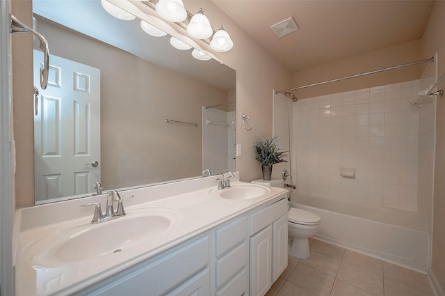 full bathroom with shower / bath combination, toilet, vanity, and tile patterned flooring