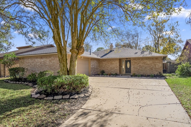 single story home featuring a garage and a front lawn