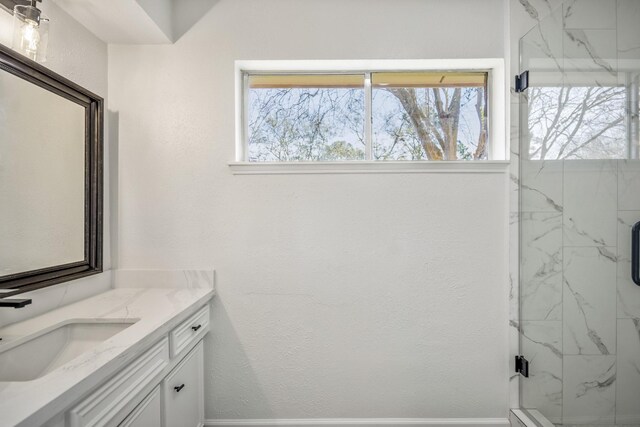 bathroom featuring vanity and an enclosed shower