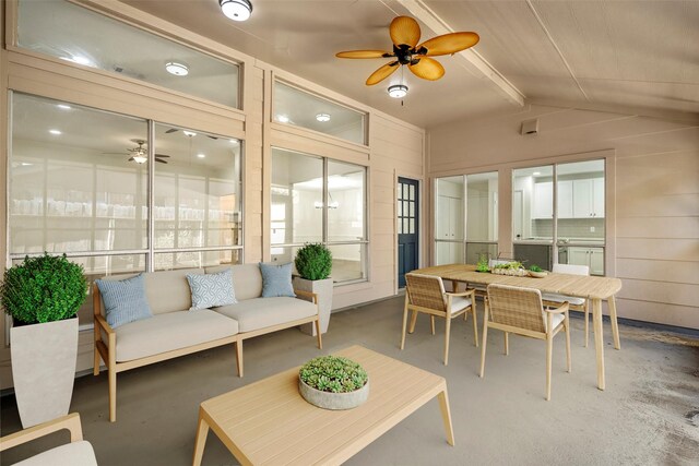 interior space featuring ceiling fan and vaulted ceiling with beams