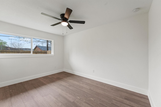 empty room featuring ceiling fan and hardwood / wood-style flooring