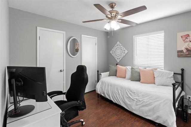 bedroom with ceiling fan and dark wood-type flooring