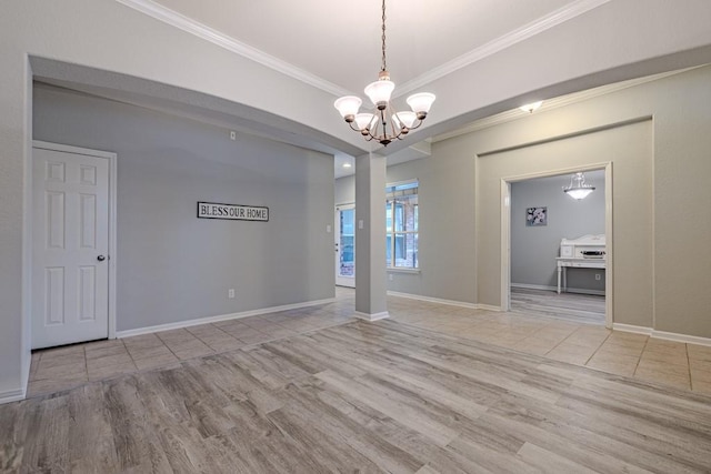 unfurnished room featuring an inviting chandelier, ornamental molding, and light hardwood / wood-style floors