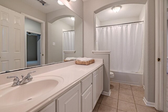 full bathroom with toilet, tile patterned flooring, shower / bath combo, and vanity