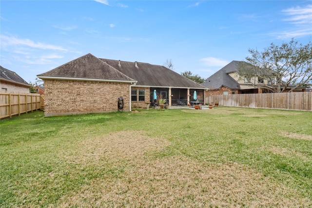 rear view of house featuring a lawn and a patio