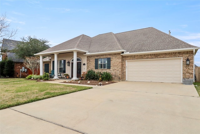 view of front facade featuring an attached garage, brick siding, concrete driveway, roof with shingles, and a front lawn