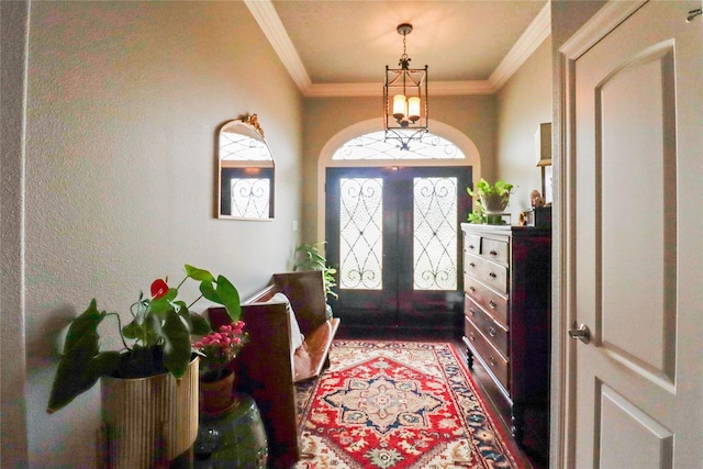 foyer with french doors, crown molding, and hardwood / wood-style floors