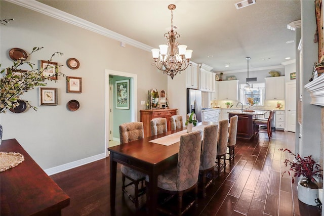 dining room with dark wood-style floors, baseboards, visible vents, and crown molding