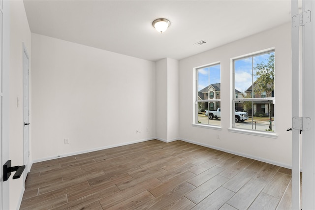 unfurnished room with wood-type flooring