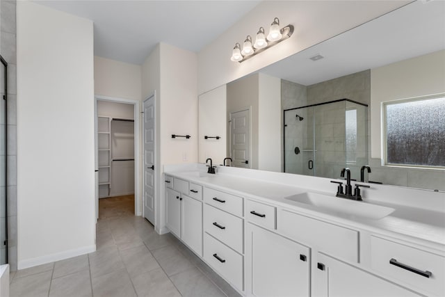 bathroom featuring vanity, tile patterned flooring, and a shower with door