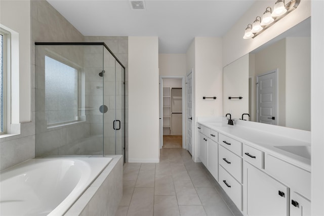 bathroom with vanity, tile patterned floors, and shower with separate bathtub