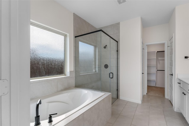 bathroom with vanity, independent shower and bath, and tile patterned floors