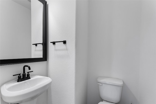 bathroom with sink and toilet