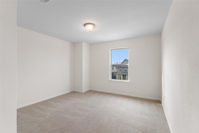 unfurnished room featuring light colored carpet