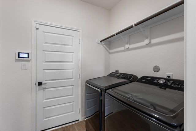 laundry room featuring washer and dryer and hardwood / wood-style floors