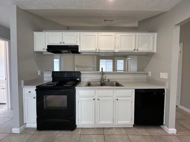 kitchen with sink, white cabinetry, ventilation hood, and black appliances