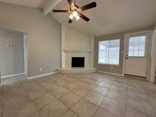 unfurnished living room featuring ceiling fan, light tile patterned floors, lofted ceiling with beams, and a fireplace