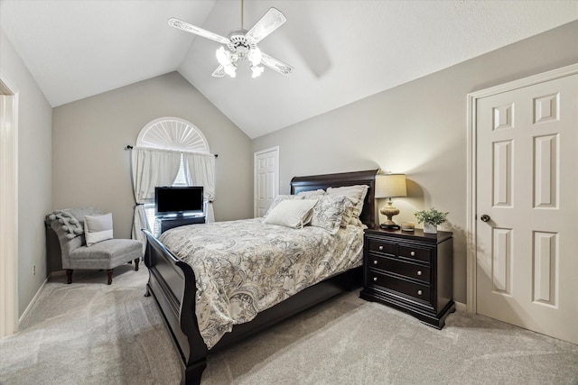 carpeted bedroom featuring ceiling fan and lofted ceiling