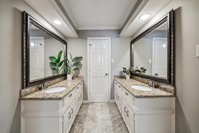 bathroom with ornamental molding and vanity