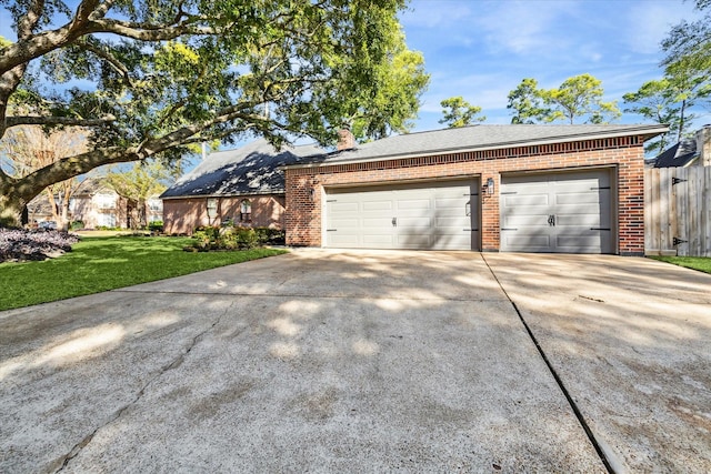 ranch-style house with a garage and a front yard