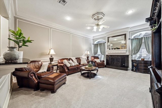 carpeted living room with ceiling fan and crown molding