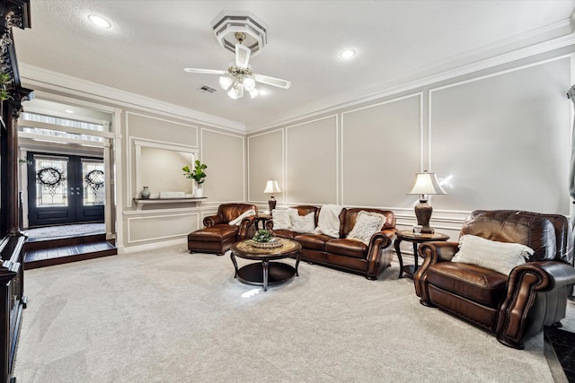 living room with carpet floors, ceiling fan, french doors, and ornamental molding