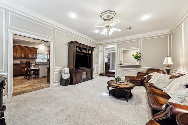 living room with light carpet, ceiling fan, crown molding, and sink