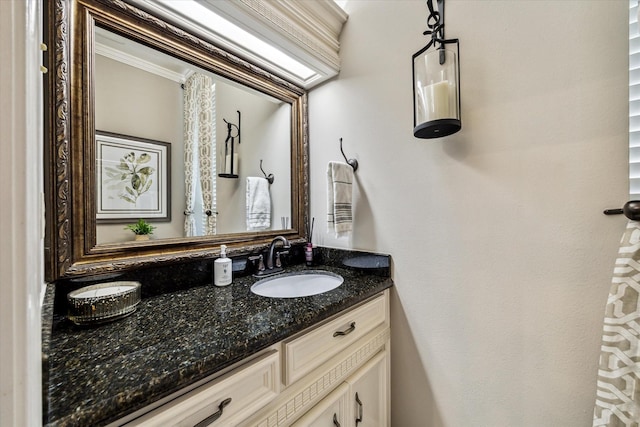 bathroom featuring ornamental molding and vanity