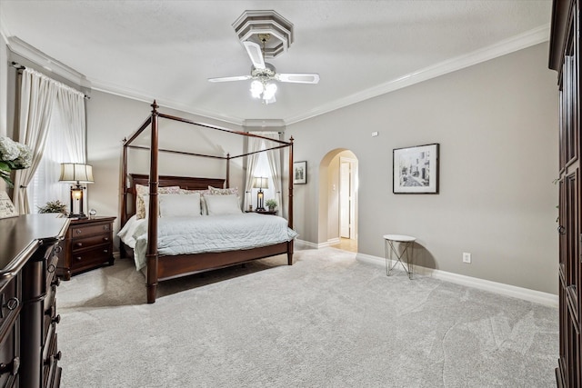 bedroom featuring light carpet, ceiling fan, and crown molding