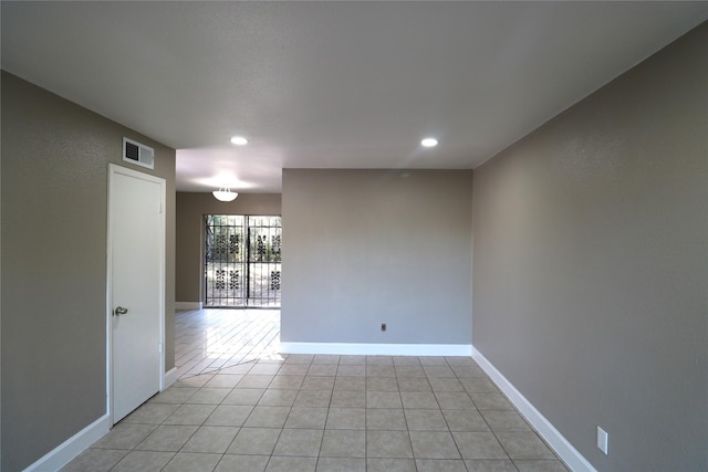 spare room featuring light tile patterned flooring