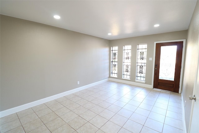 tiled entrance foyer featuring a healthy amount of sunlight