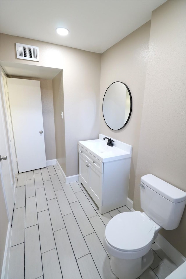 bathroom featuring toilet and vanity