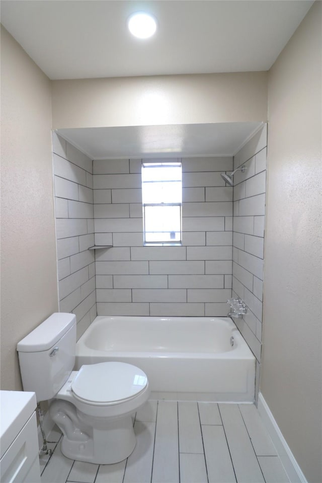 full bathroom featuring toilet, tiled shower / bath combo, tile patterned flooring, and vanity