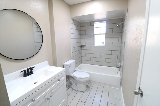 full bathroom featuring toilet, tiled shower / bath, and vanity