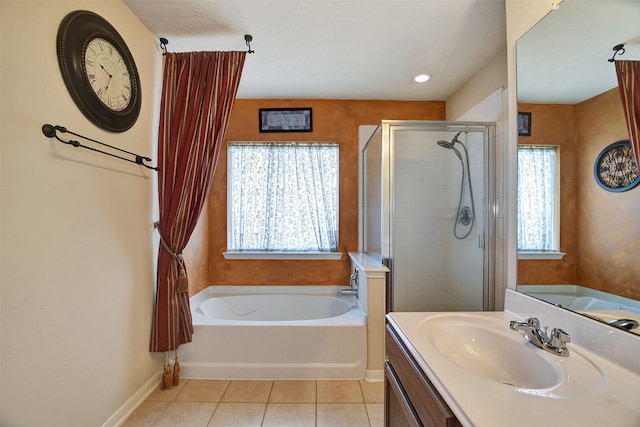 bathroom with tile patterned flooring, vanity, and separate shower and tub