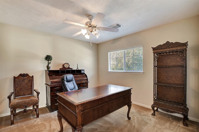 carpeted office with ceiling fan and a textured ceiling