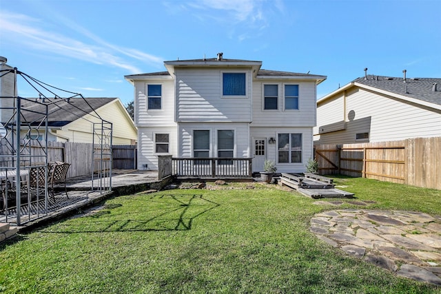 back of property with a wooden deck, a yard, and a patio area