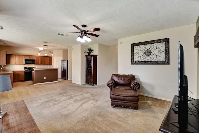 living room with sink, a textured ceiling, light colored carpet, and ceiling fan