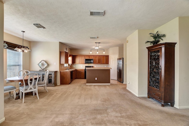 kitchen with a center island, hanging light fixtures, stainless steel fridge, electric stove, and light colored carpet