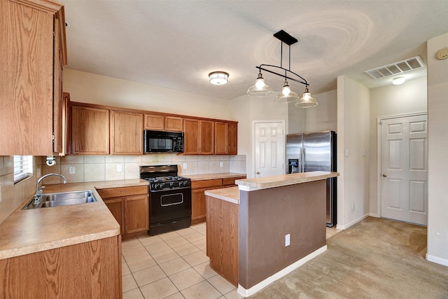 kitchen featuring pendant lighting, sink, backsplash, a center island, and black appliances