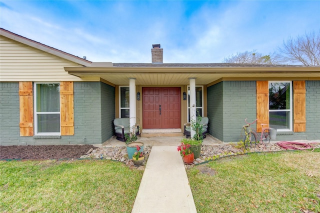 entrance to property featuring a yard