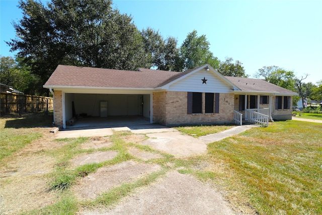 single story home with a front lawn and a carport