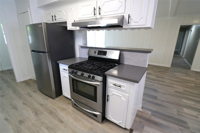 kitchen with light hardwood / wood-style floors, white cabinetry, and appliances with stainless steel finishes