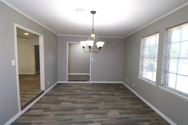 unfurnished dining area with a healthy amount of sunlight, dark hardwood / wood-style flooring, an inviting chandelier, and ornamental molding