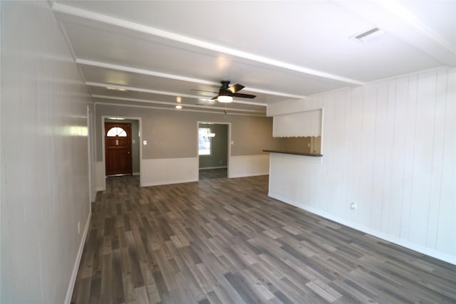 unfurnished living room featuring ceiling fan and dark hardwood / wood-style floors