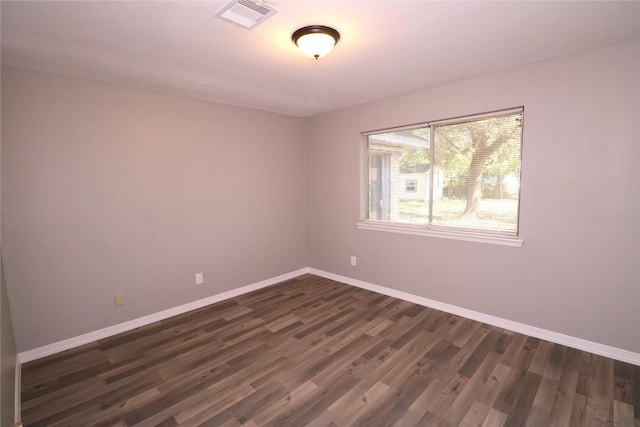 unfurnished room with dark hardwood / wood-style flooring